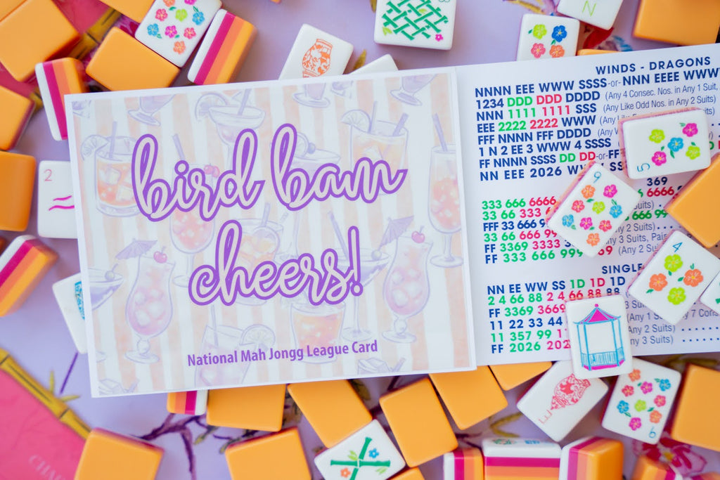 Colorful Mahjong tiles with a card that says 'bird bam cheers!' on a multicolored background.